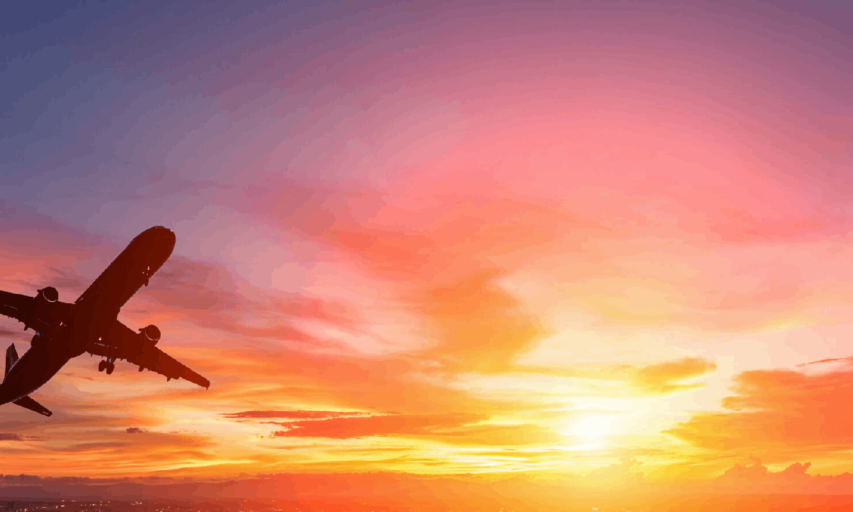 Interstate Funeral Regulations in Australia: What You Need to Know An aeroplane flying across a vivid orange and pink sunset sky.